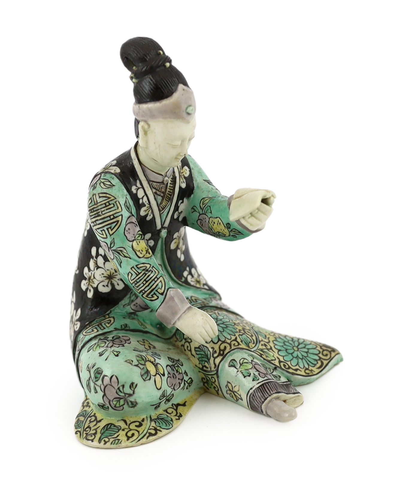 A Chinese susancai figure of a seated woman, Kangxi period, some restoration